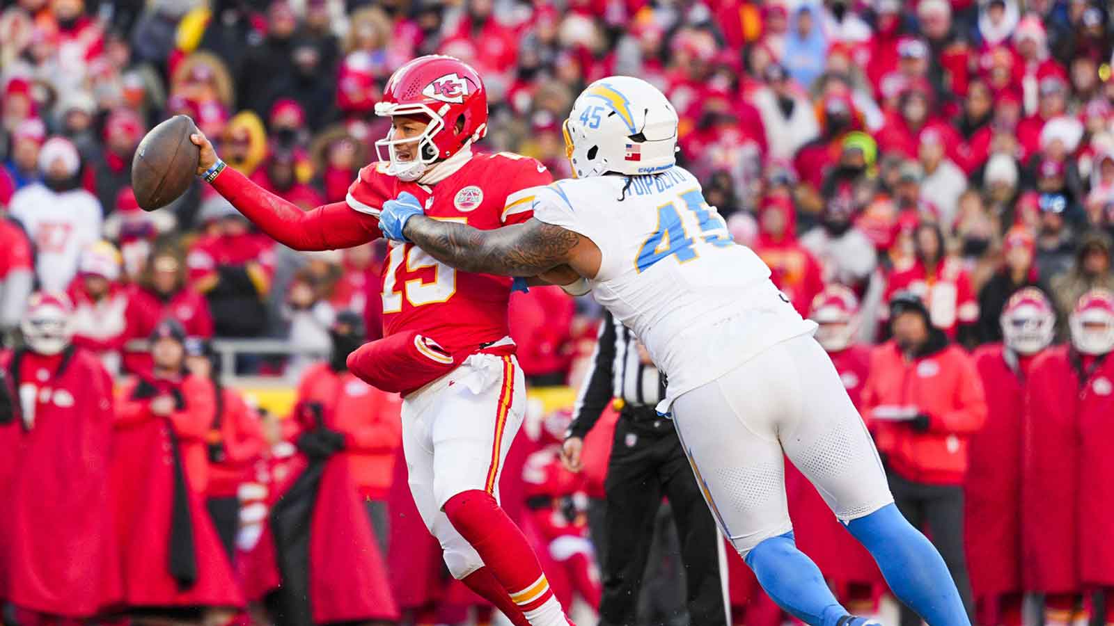 Los Angeles Chargers linebacker Tuli Tuipulotu (45) pressures Kansas City Chiefs quarterback Patrick Mahomes (15) during the fourth quarter at GEHA Field at Arrowhead Stadium.