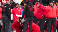 Kansas City Chiefs quarterback Patrick Mahomes (15) is attended to by team medical staff following an injury during the fourth quarter against the Los Angeles Chargers at GEHA Field at Arrowhead Stadium. Kansas City Chiefs head coach Andy Reid, second from right, watches.
