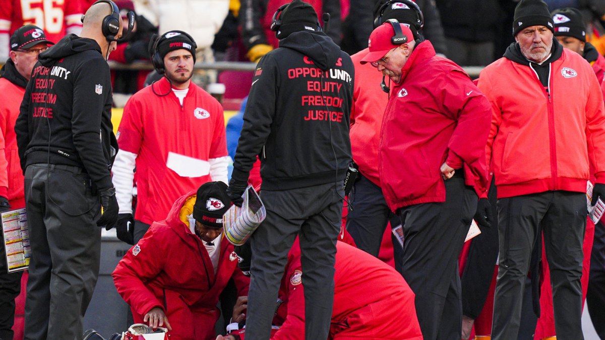 Kansas City Chiefs quarterback Patrick Mahomes (15) is attended to by team medical staff following an injury during the fourth quarter against the Los Angeles Chargers at GEHA Field at Arrowhead Stadium. Kansas City Chiefs head coach Andy Reid, second from right, watches.