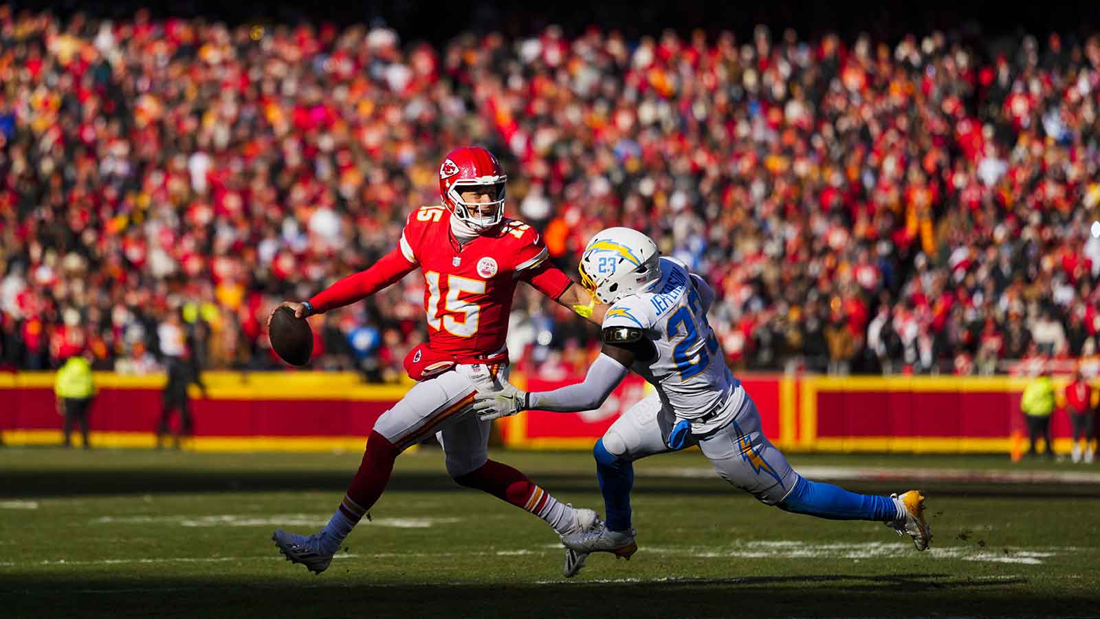 Kansas City Chiefs quarterback Patrick Mahomes (15) looks to pass under pressure from Los Angeles Chargers safety Tony Jefferson (23) during the second quarter at GEHA Field at Arrowhead Stadium.