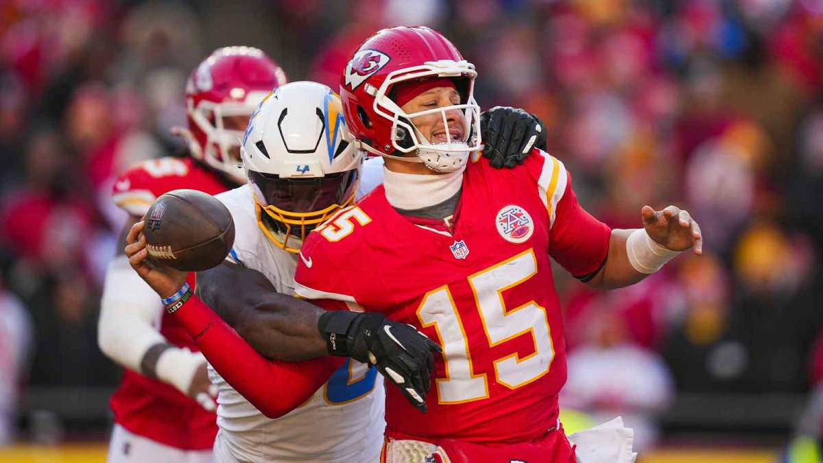 Los Angeles Chargers linebacker Odafe Oweh (98) sacks Kansas City Chiefs quarterback Patrick Mahomes (15) during the second half at GEHA Field at Arrowhead Stadium.