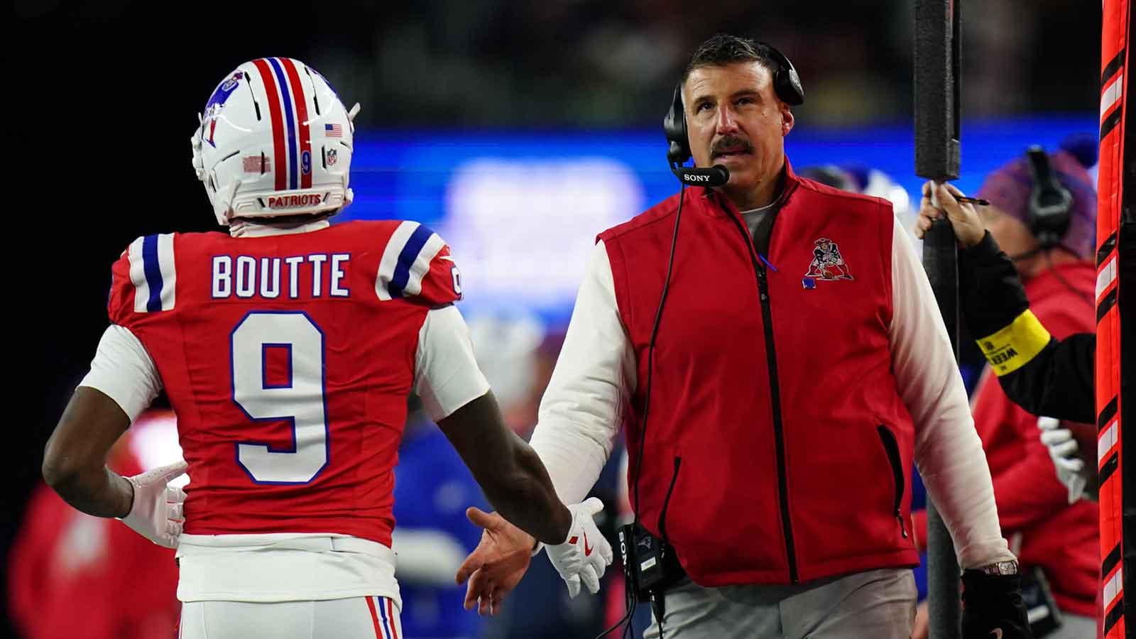 New England Patriots wide receiver Kayshon Boutte (9) high-fives New England Patriots head coach Mike Vrabel on the sideline during the third quarter at Gillette Stadium.