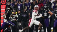 New England Patriots wide receiver Stefon Diggs (8) runs after a catch against Baltimore Ravens cornerback Marlon Humphrey (44) during the first half of the game at M&T Bank Stadium.