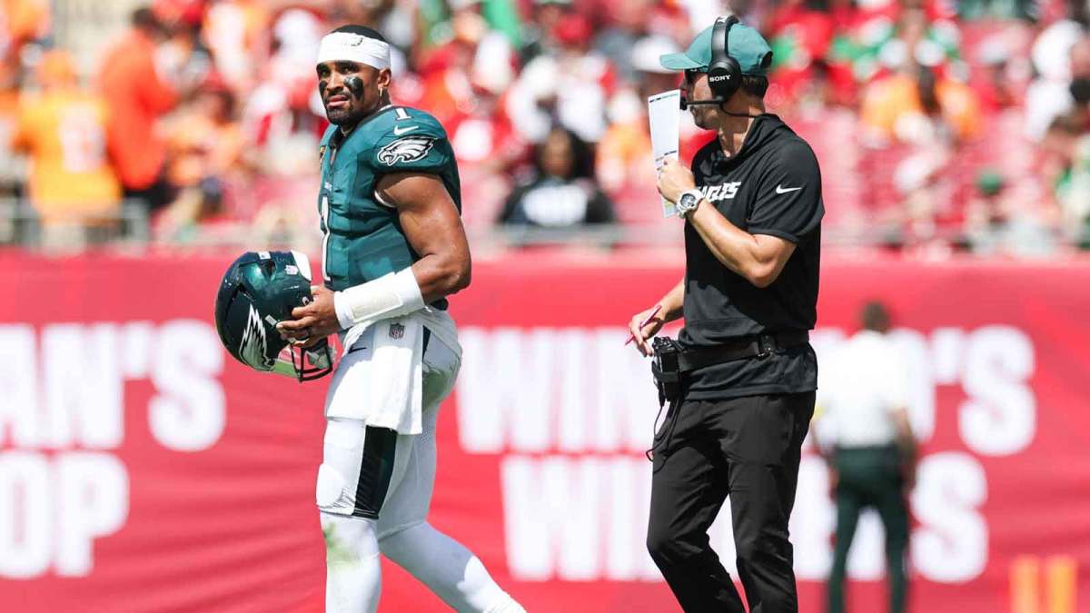 Philadelphia Eagles offensive coach Kevin Patullo communicates with quarterback Jalen Hurts (1) during a timeout in the second quarter against the Tampa Bay Buccaneers at Raymond James Stadium.