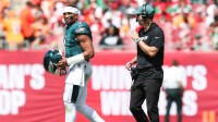 Philadelphia Eagles offensive coach Kevin Patullo communicates with quarterback Jalen Hurts (1) during a timeout in the second quarter against the Tampa Bay Buccaneers at Raymond James Stadium.