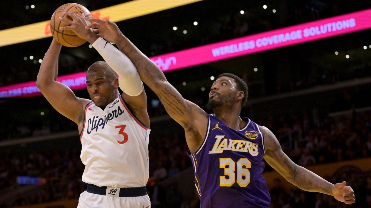 Los Angeles Clippers guard Chris Paul (3) beats Los Angeles Lakers guard Marcus Smart (36) to a rebound during the first half at Crypto.com Arena.