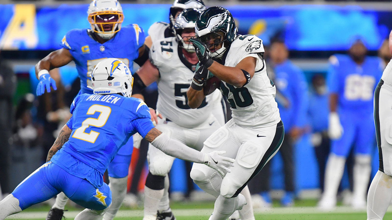 Philadelphia Eagles running back Saquon Barkley (26) runs against Los Angeles Chargers cornerback Elijah Molden (2) in the first half at SoFi Stadium.