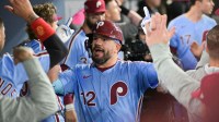 Philadelphia Phillies designated hitter Kyle Schwarber (12) celebrates in the dugout after hitting a solo home run during the fourth inning against the Los Angeles Dodgers during game three of the NLDS round for the 2025 MLB playoffs at Dodger Stadium.
