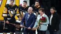 Pittsburgh Penguins center Evgeni Malkin (71) is joined by teammates center Sidney Crosby (rear center), defenseman Kris Letang (rear right) along with son Nakita Malkin, father Vladimir Malkin, mother Natalia Malkin and Fenway Sports Group chairman Tom Werner (right) as he is honored for recording his 500th NHL goal earlier in the season before a game against the Detroit Red Wings at PPG Paints Arena.