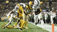 Green Bay Packers wide receiver Savion Williams (83) scores a touchdown against Pittsburgh Steelers cornerback Darius Slay (23) during the third quarter at Acrisure Stadium.