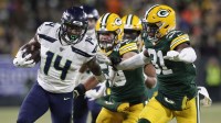 Seattle Seahawks wide receiver D.K. Metcalf (14) tries to get away from Green Bay Packers strong safety Adrian Amos (31) in the third quarter of a NFC Divisional Round playoff football game at Lambeau Field.