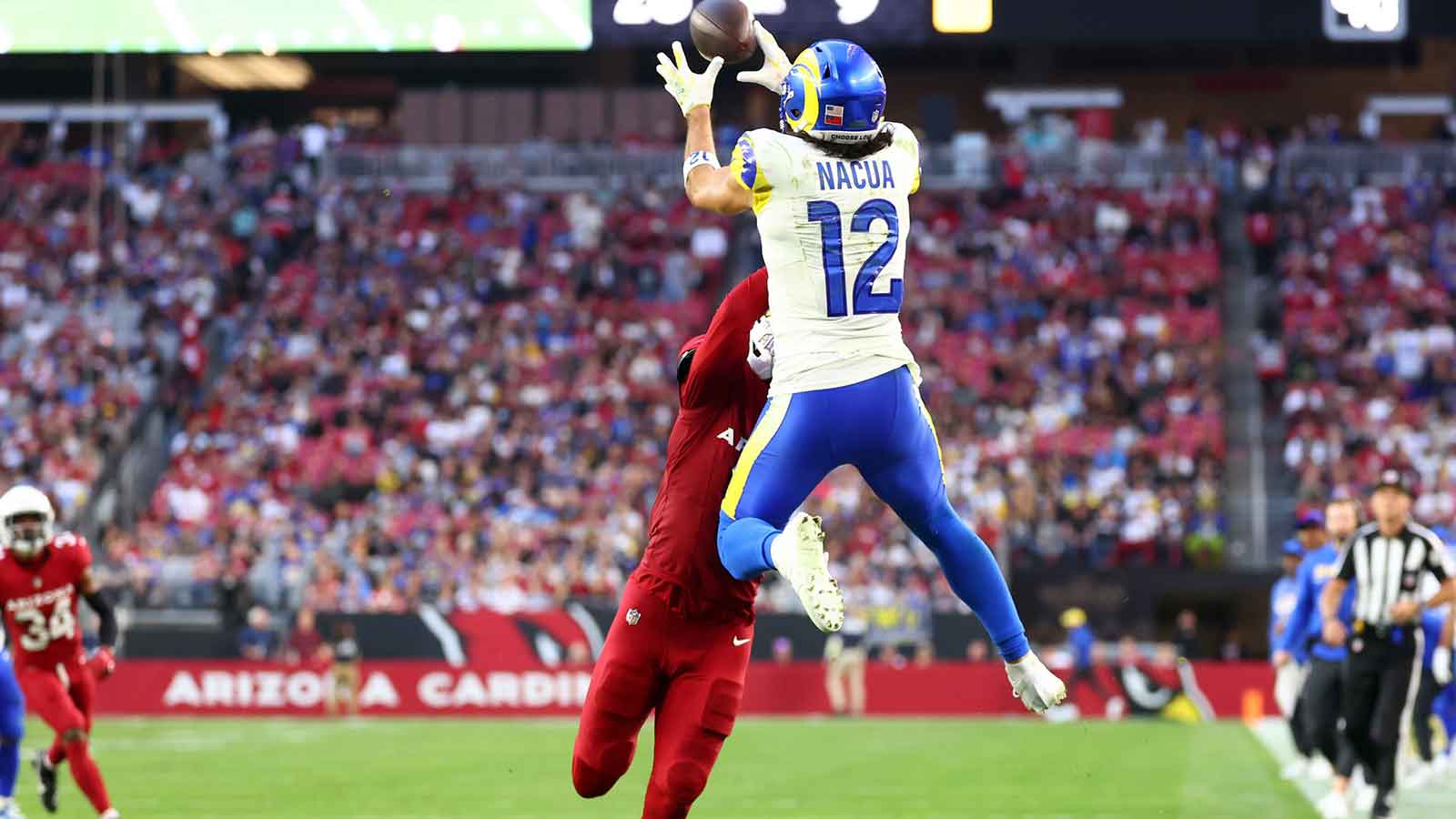Los Angeles Rams wide receiver Puka Nacua (12) makes a catch for a touchdown against the Arizona Cardinals during the second half at State Farm Stadium. 