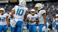 Los Angeles Chargers quarterback Justin Herbert (10) celebrates his touchdown with wide receiver Quentin Johnston (1) against the Tennessee Titans during the first half at Nissan Stadium.