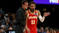 Atlanta Hawks head coach Quin Snyder (left) talks with Atlanta Hawks guard Trae Young (11) during the first quarter against the Memphis Grizzlies at FedExForum.