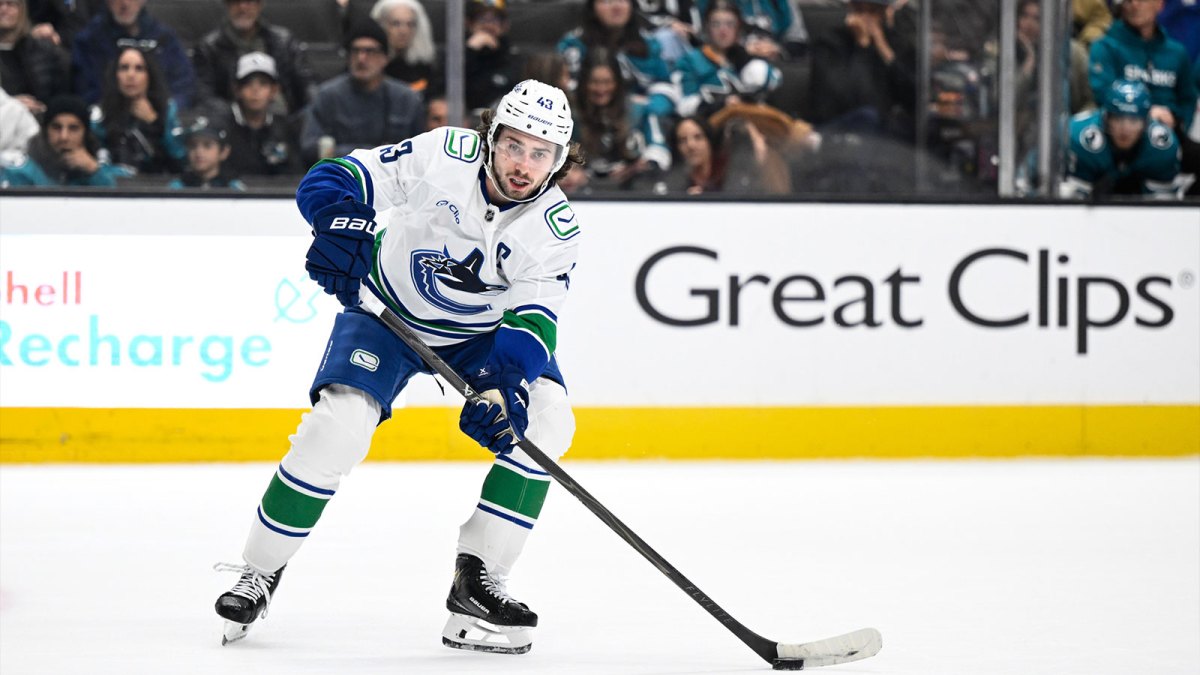 Vancouver Canucks defenseman Quinn Hughes (43) controls the puck against the San Jose Sharks in the third period at SAP Center at San Jose.