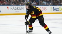 Vancouver Canucks defenseman Quinn Hughes (43) handles the puck against the Detroit Red Wings in the second period at Rogers Arena.