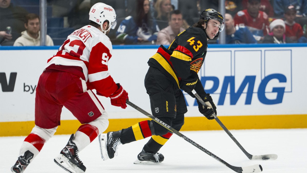 Dec 8, 2025; Vancouver, British Columbia, CAN; Detroit Red Wings forward Alex DeBrincat (93) defends against Vancouver Canucks defenseman Quinn Hughes (43) in the second period at Rogers Arena.