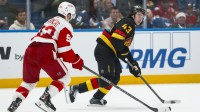 Dec 8, 2025; Vancouver, British Columbia, CAN; Detroit Red Wings forward Alex DeBrincat (93) defends against Vancouver Canucks defenseman Quinn Hughes (43) in the second period at Rogers Arena.