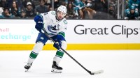 Vancouver Canucks defenseman Quinn Hughes (43) controls the puck against the San Jose Sharks in the third period at SAP Center at San Jose.