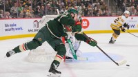 Minnesota Wild defensemen Quinn Hughes (43) makes a pass against the Boston Bruins during the first period at Grand Casino Arena