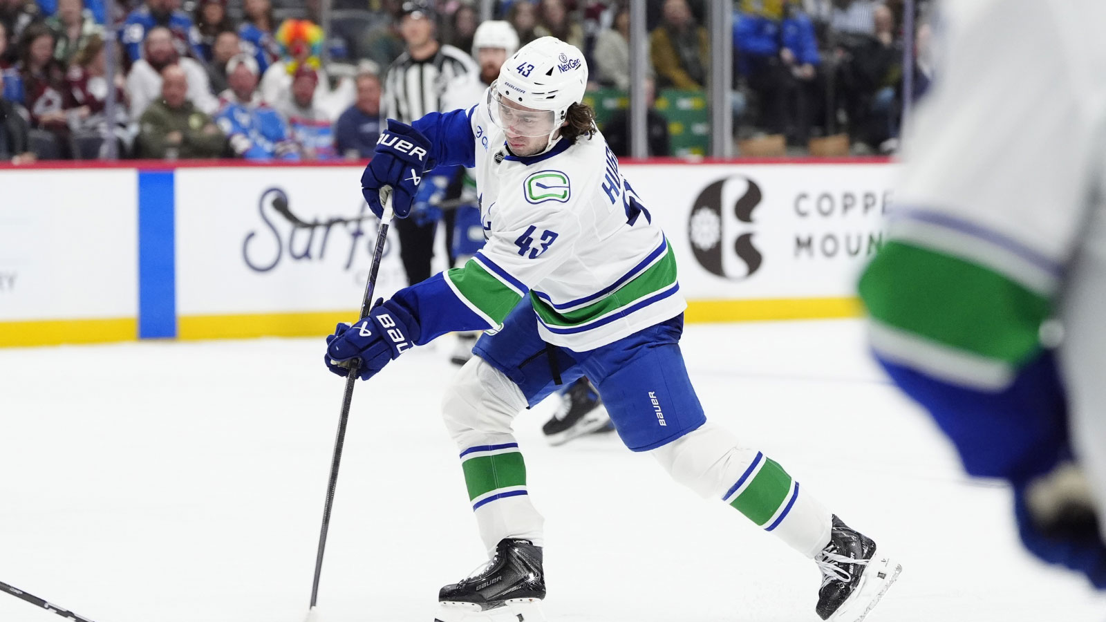 Vancouver Canucks defenseman Quinn Hughes (43) takes a shot on goal in the third period against the Colorado Avalanche at Ball Arena.