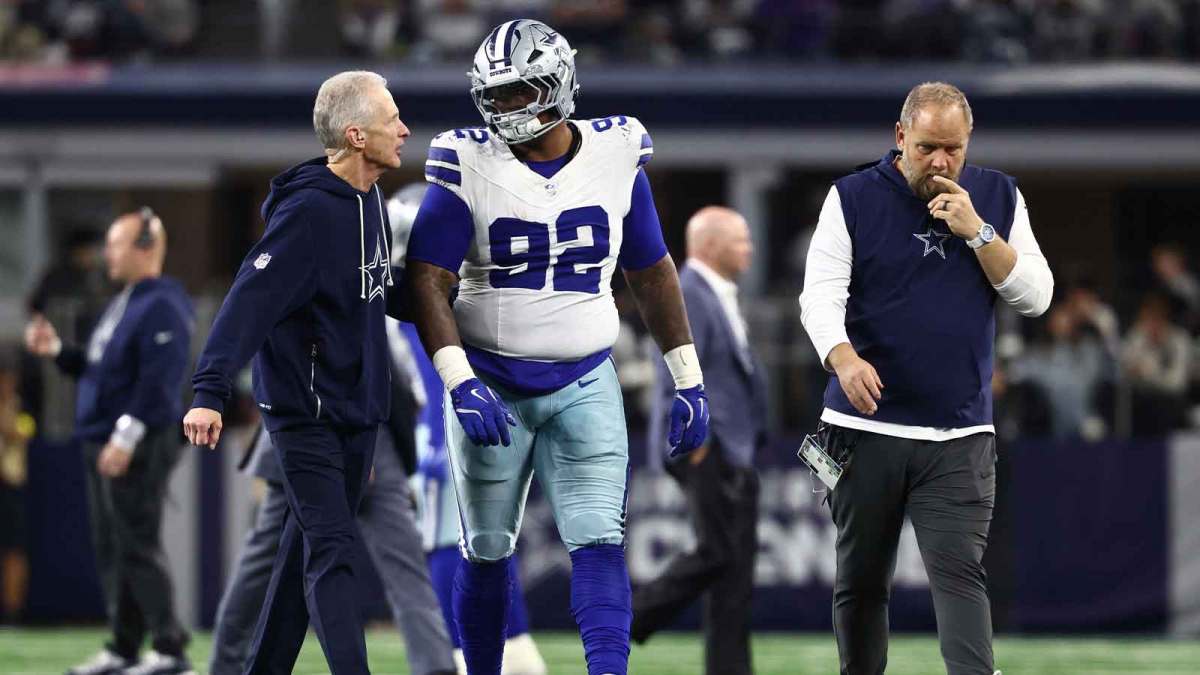 Dallas Cowboys defensive tackle Quinnen Williams (92) walks off the field with trainers after an injury during the second half against the Minnesota Vikings at AT&T Stadium. Mandatory Credit: Kevin Jairaj-Imagn Images