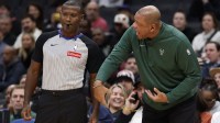 Milwaukee Bucks head coach Doc Rivers (R) argues with referee James Williams (60) against the Washington Wizards in the first quarter at Capital One Arena.