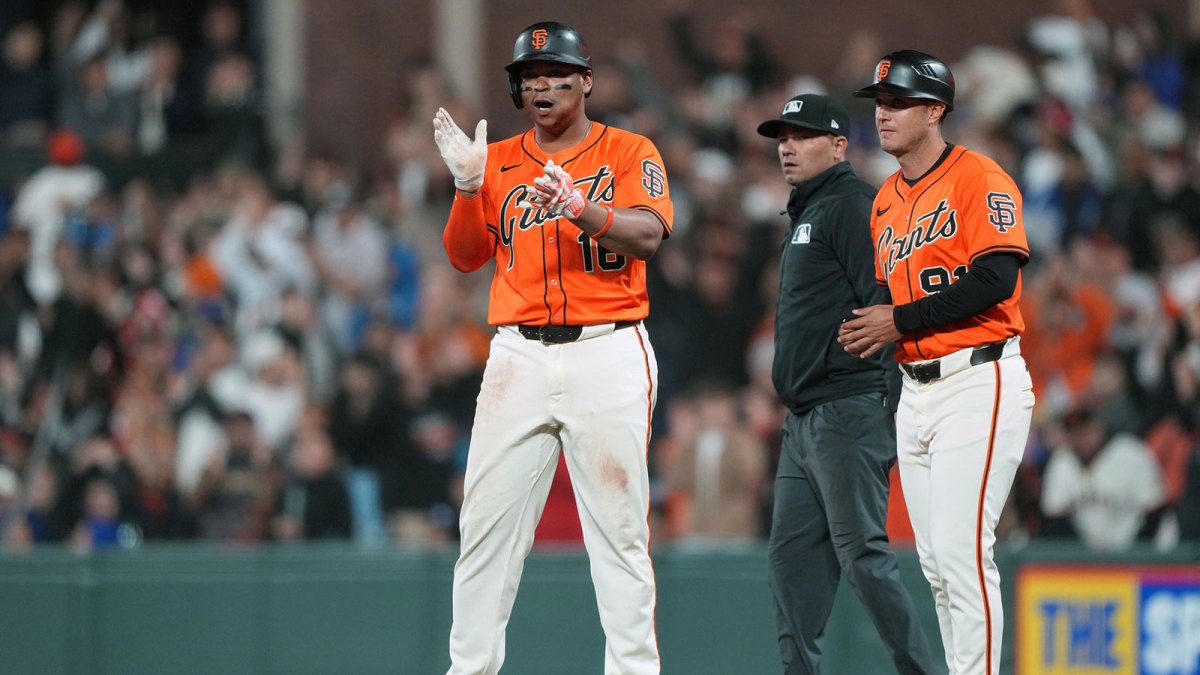 San Francisco Giants designated hitter Rafael Devers (center) reacts after hitting a single against the Los Angeles Dodgers during the ninth inning at Oracle Park.