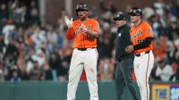 San Francisco Giants designated hitter Rafael Devers (center) reacts after hitting a single against the Los Angeles Dodgers during the ninth inning at Oracle Park.