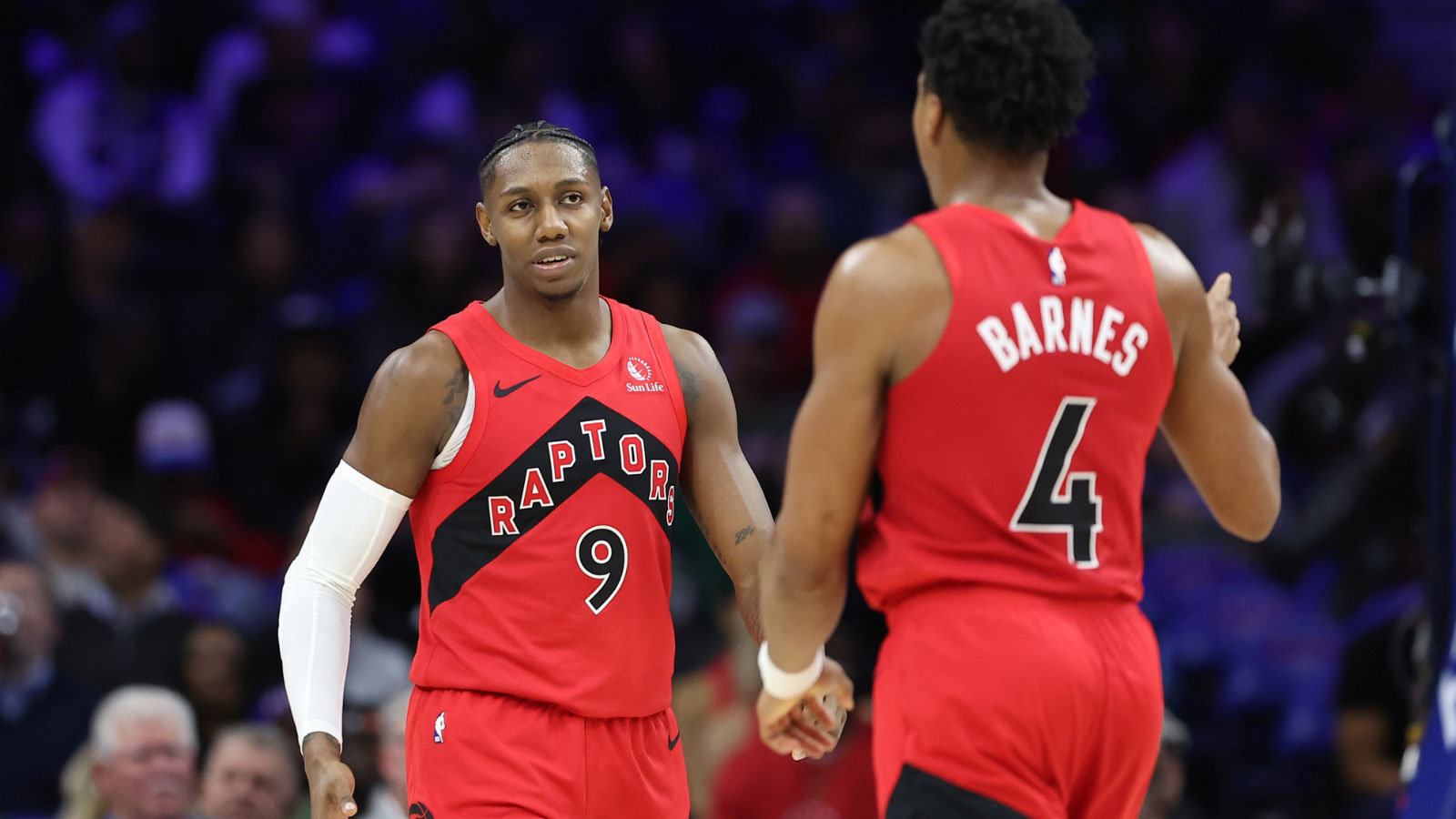Raptors forward RJ Barrett (9) and forward Scottie Barnes (4) react after a score against the Philadelphia 76ers during the third quarter at Xfinity Mobile Arena