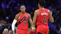 Raptors forward RJ Barrett (9) and forward Scottie Barnes (4) react after a score against the Philadelphia 76ers during the third quarter at Xfinity Mobile Arena