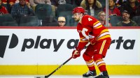 Calgary Flames defenseman Rasmus Andersson (4) controls the puck against the Seattle Kraken during the second period at Scotiabank Saddledome.
