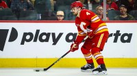 Calgary Flames defenseman Rasmus Andersson (4) controls the puck against the Seattle Kraken during the second period at Scotiabank Saddledome.