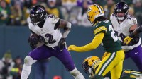 Baltimore Ravens running back Derrick Henry (22) slips out of a tackle by Green Bay Packers linebacker Edgerrin Cooper (56) on Saturday, December 27, 2025, at Lambeau Field in Green Bay, Wis. The Ravens won the game, 41-24.