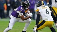 Baltimore Ravens tight end Isaiah Likely (80) runs with the ball against Pittsburgh Steelers linebacker Patrick Queen (6) during the first half at M&T Bank Stadium.