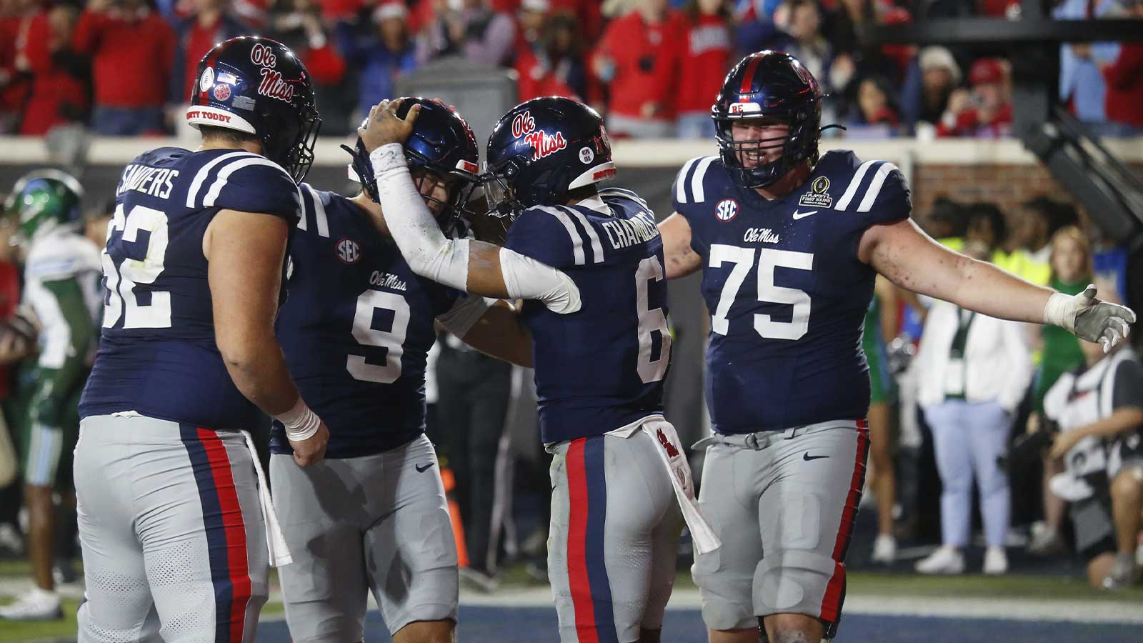 Mississippi Rebels quarterback Trinidad Chambliss (6) reacts with teammates after scoring a touchdown against the Tulane Green Wave during the second half of a game at Vaught-Hemingway Stadium.