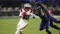 New England Patriots running back Rhamondre Stevenson (38) runs the ball against Baltimore Ravens safety Alohi Gilman (12) and linebacker Trenton Simpson (32) during the second half of the game at M&T Bank Stadium.