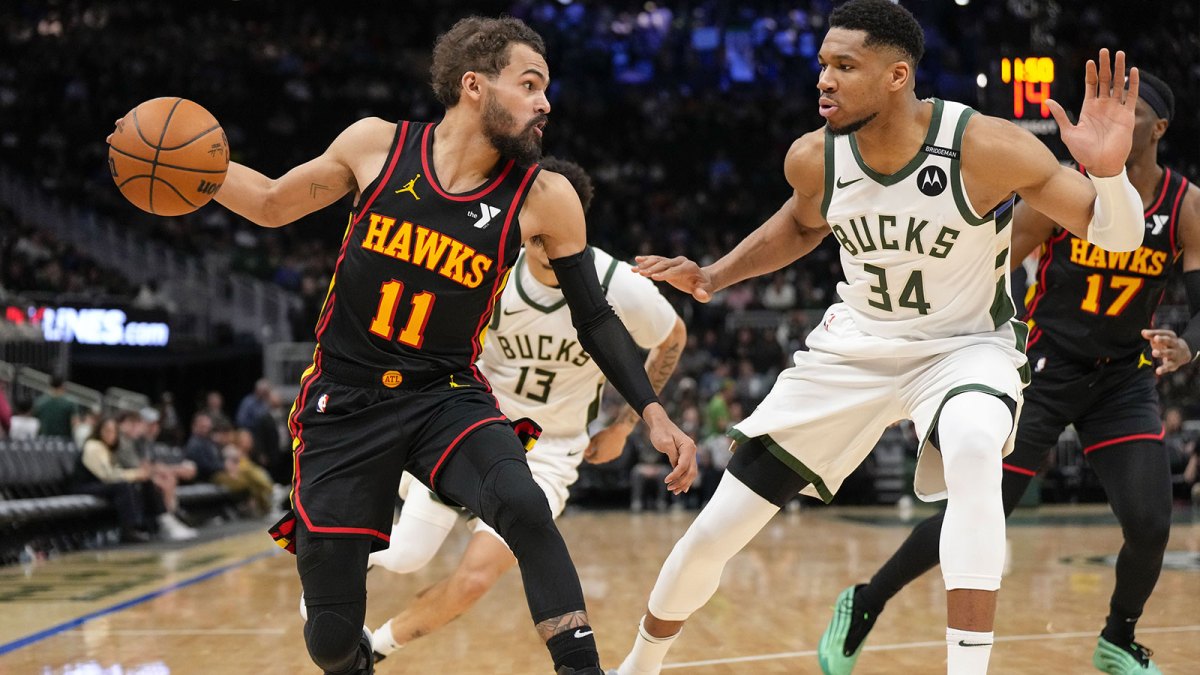 Atlanta Hawks guard Trae Young (11) dribbles the ball under pressure from Milwaukee Bucks forward Giannis Antetokounmpo (34) during the third quarter at Fiserv Forum.