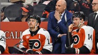 Philadelphia Flyers head coach Rick Tocchet with right wing Travis Konecny (11) and center Sean Couturier (14) against the Florida Panthers during the first period at Wells Fargo Center.