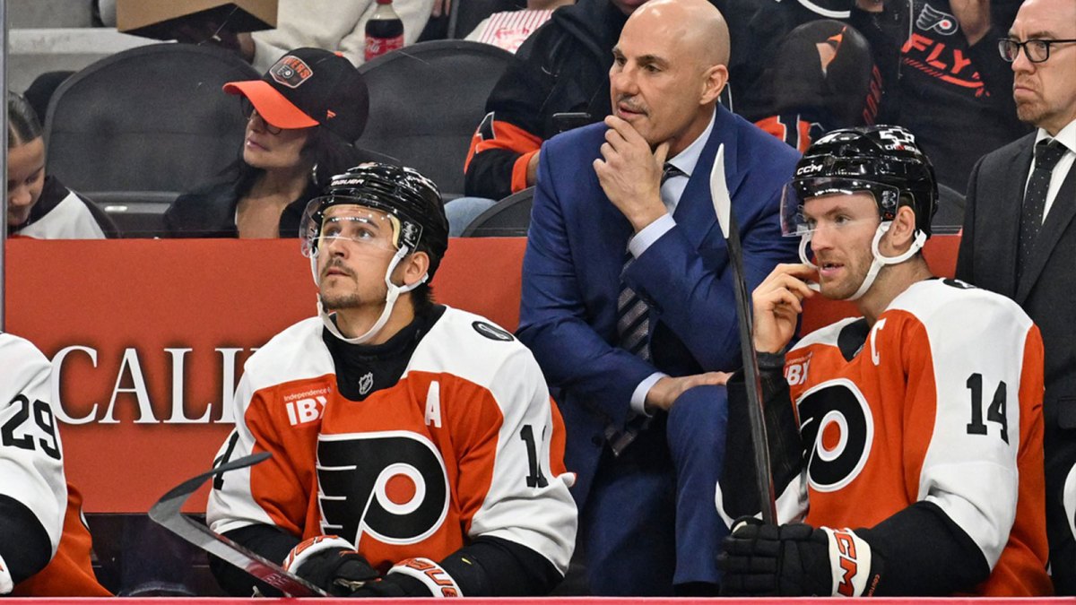 Philadelphia Flyers head coach Rick Tocchet with right wing Travis Konecny (11) and center Sean Couturier (14) against the Florida Panthers during the first period at Wells Fargo Center.