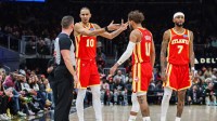 Atlanta Hawks forward Zaccharie Risacher (10), guard Trae Young (11) and guard Nickeil Alexander-Walker (7) talk to the referee after a call during the game against the Chicago Bulls during the third quarter at State Farm Arena.