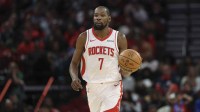 Rockets forward Kevin Durant (7) dribbles the ball during the first half against the Phoenix Suns at Toyota Center with ESPN's Kendrick Perkins in the background