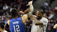 Thunder center Steven Adams (12) goes through a pre-game ritual with Oklahoma City Thunder forward Kevin Durant before the start of the game at the Moda Center at the Rose Quarter with the Rockets logo in the background
