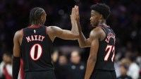 Philadelphia 76ers guard Tyrese Maxey (0) and guard VJ Edgecombe (77) high five after a score during the fourth quarter against the Toronto Raptors at Xfinity Mobile Arena.