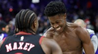 Philadelphia 76ers guard VJ Edgecombe reacts with guard Tyrese Maxey (0) after a victory against the Golden State Warriors at Xfinity Mobile Arena.