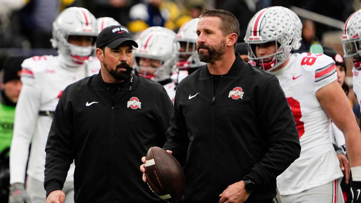 Ohio State Buckeyes offensive coordinator Brian Hartline and head coach Ryan Day leads warm ups during the NCAA football game against the Michigan Wolverines at Michigan Stadium in Ann Arbor, Mich. on Nov. 29, 2025. Ohio State won 27-9.