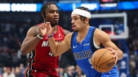 Dallas Mavericks guard Ryan Nembhard (9) drives to the basket as Miami Heat guard Davion Mitchell (45) defends during the first quarter at American Airlines Center.