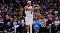 Dallas Mavericks guard Ryan Nembhard (9) gestures as he dribbles the ball up court in the fourth quarter against the Denver Nuggets at Ball Arena.