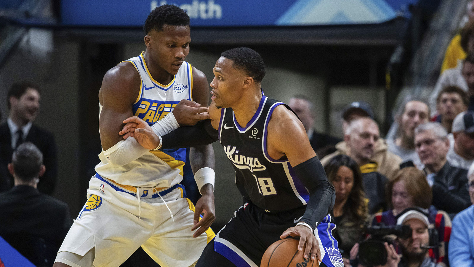 Sacramento Kings guard Russell Westbrook (18) dribbles the ball while Indiana Pacers guard Bennedict Mathurin (00) defends in the first half at Gainbridge Fieldhouse.