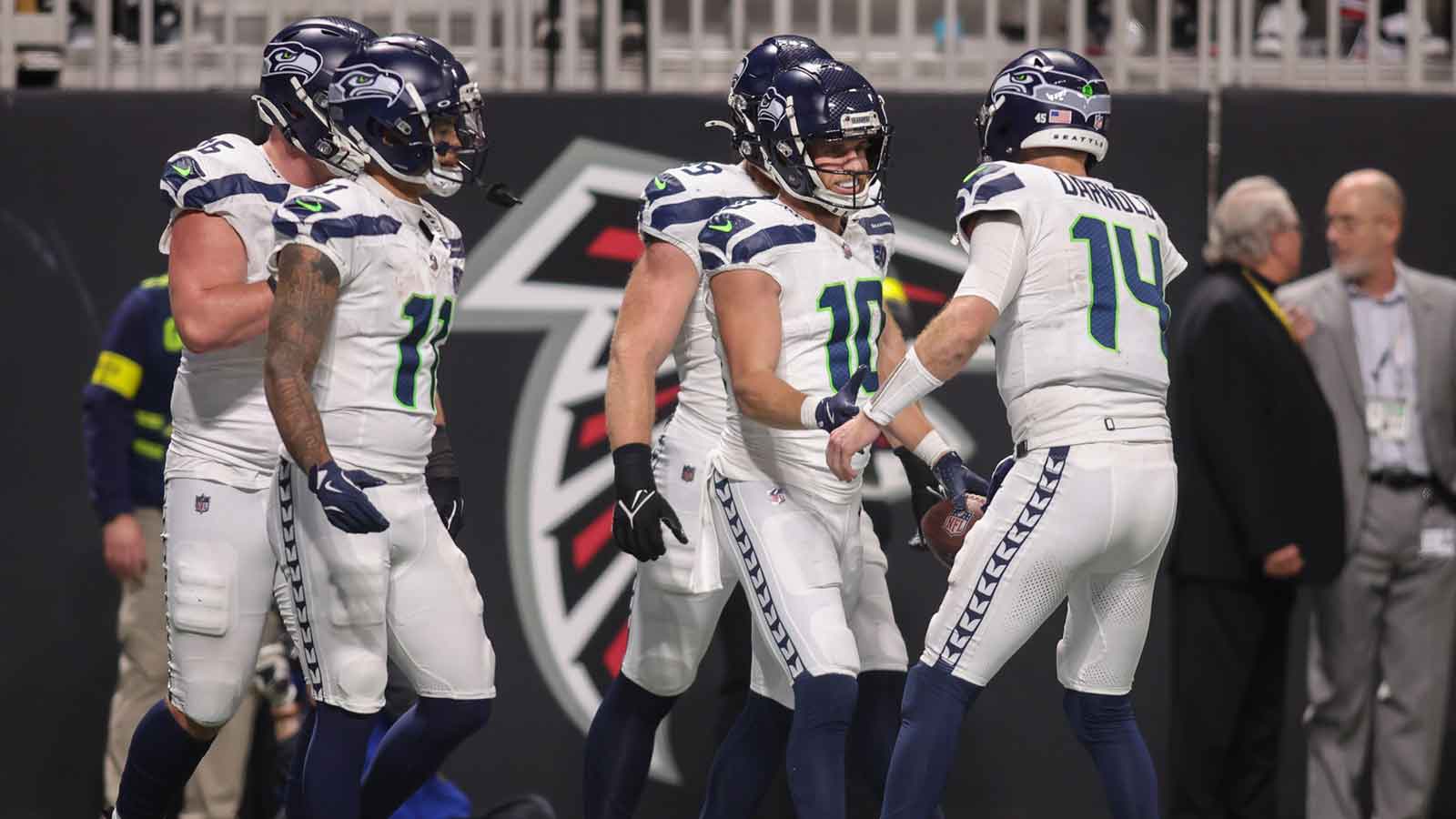 Seattle Seahawks wide receiver Cooper Kupp (10) celebrates with quarterback Sam Darnold (14) after a touchdown catch against the Atlanta Falcons in the fourth quarter at Mercedes-Benz Stadium.